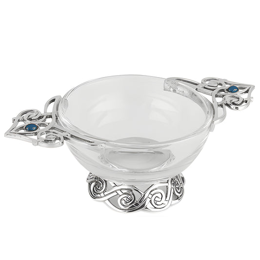 Celtic quaich bowl with glass body and pewter handles featuring blue stones.