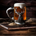 Glass and pewter stag tankard filled with ale on rustic wood board.