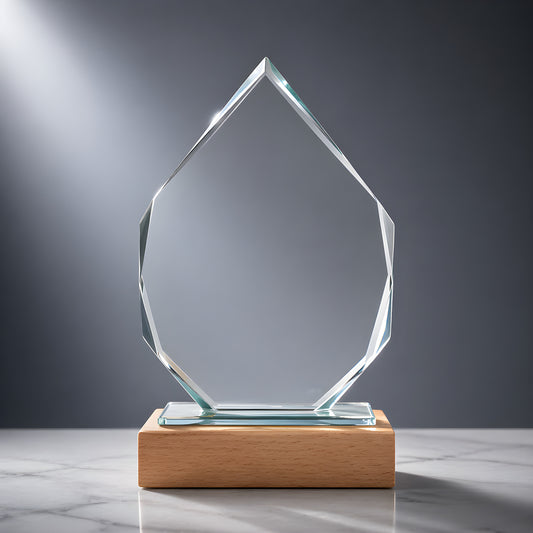 Glass iceberg-shaped award with wooden base on marble surface.