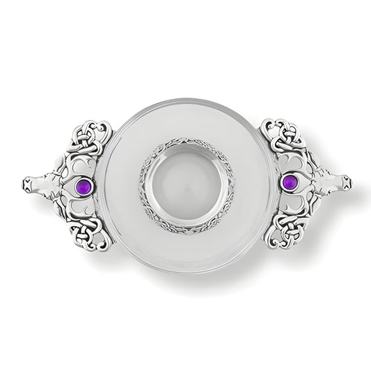 Glass quaich bowl with silver handles, Celtic design, and amethyst gems.