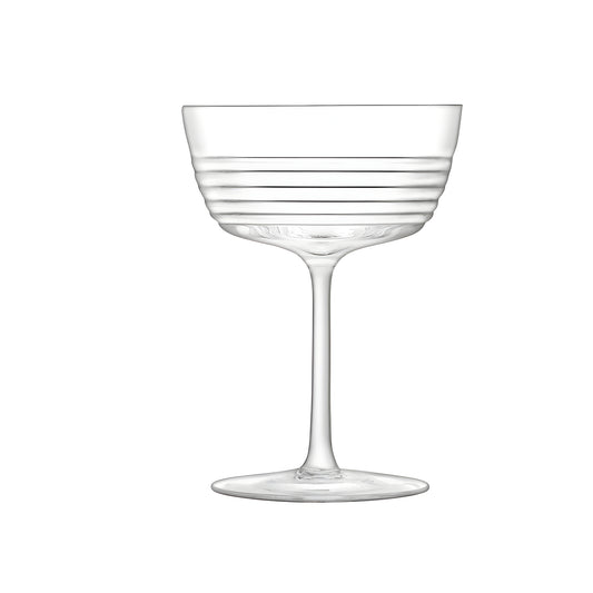 Elegant ribbed design groove glass champagne saucer on white background