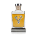 Glass pewter hip flask with engraved stag design and whiskey.