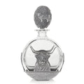 Glass decanter with a highland cow design, featuring a metal bull emblem and rustic detailing.
