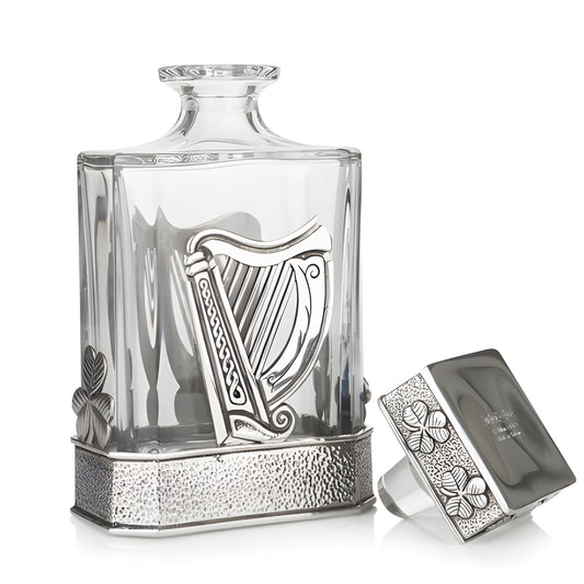 Elegant glass decanter with silver Irish harp and clover accents.