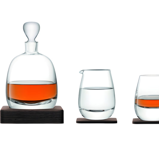 Islay whisky decanter set with glasses and water jug on wooden bases.