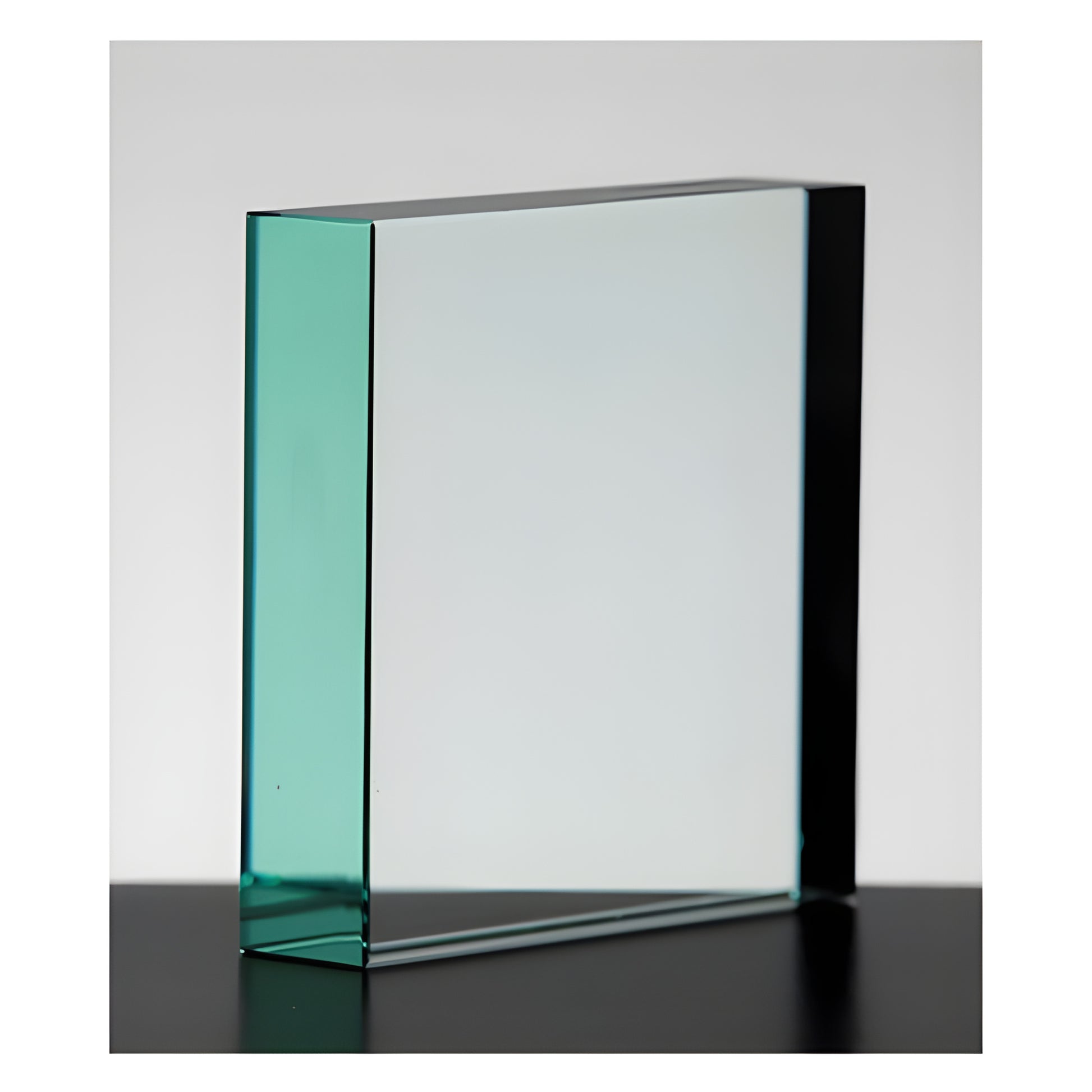 Blank jade square glass award on black surface for engraving.