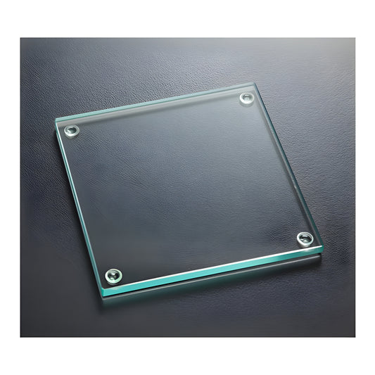 Glass square coaster with jade tint on dark surface