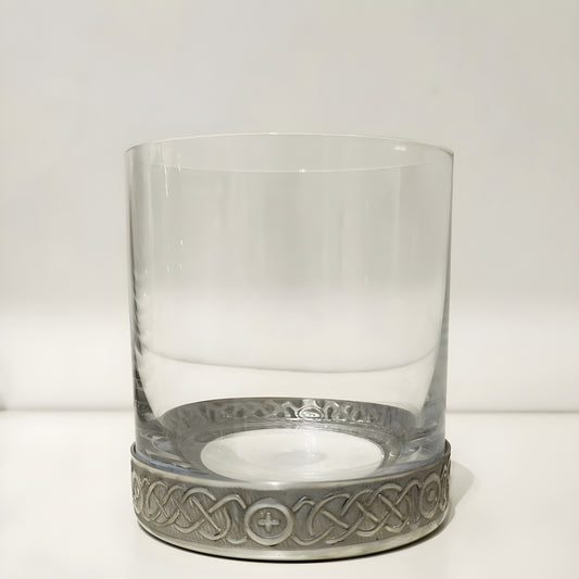 Whisky glass with a pewter base featuring a Celtic etched spiral design.
