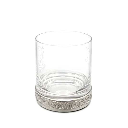 Clear whisky glass with a decorative pewter base featuring a Celtic pattern.