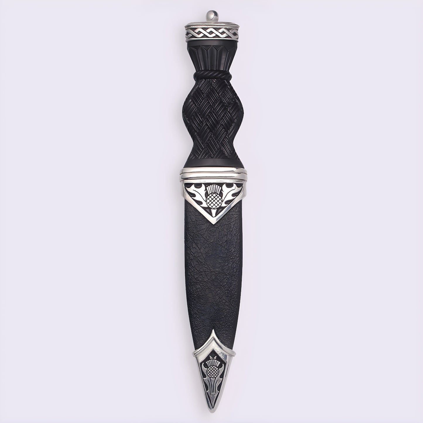 Traditional Scottish sgian dubh with black handle and thistle design.