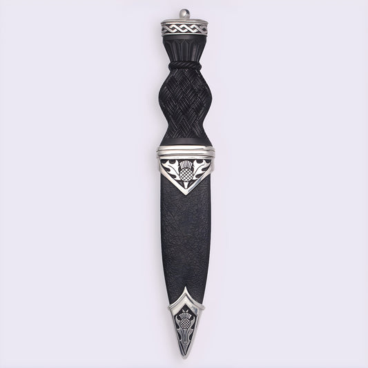 Traditional Scottish sgian dubh with black handle and thistle design.