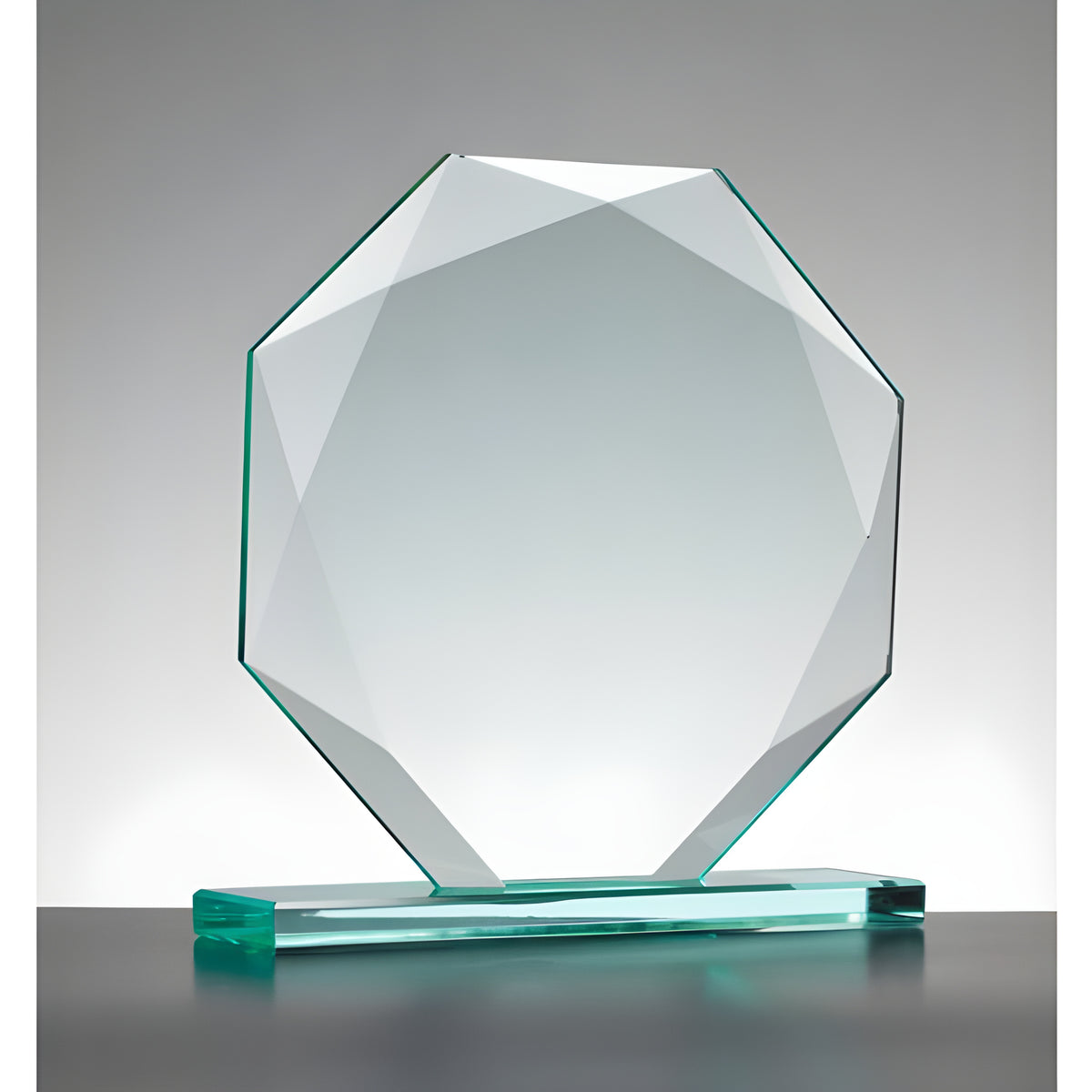 Faceted glass octagon award on base against gray background.