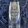 Crystal award for contributions to the Royal British Legion Knightswood displayed on blue paper.