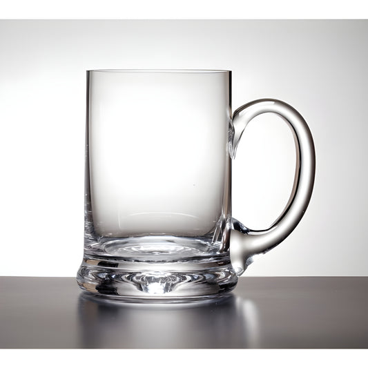 Clear glass tankard with handle on a reflective surface