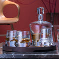 Glass decanter and whiskey glasses on a tray for a premium tasting experience.