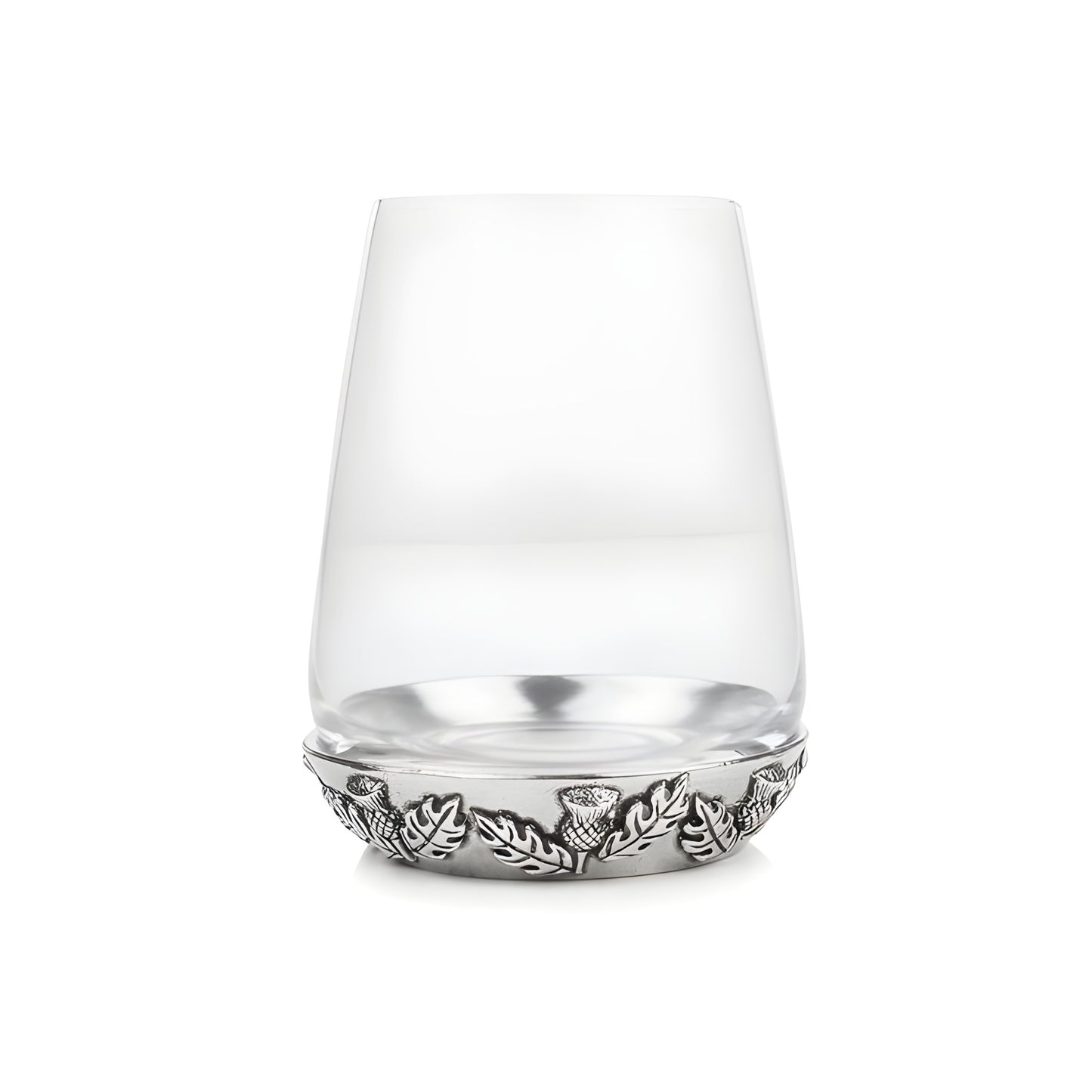 Scottish whisky glass with thistle and leaf design on the base.
