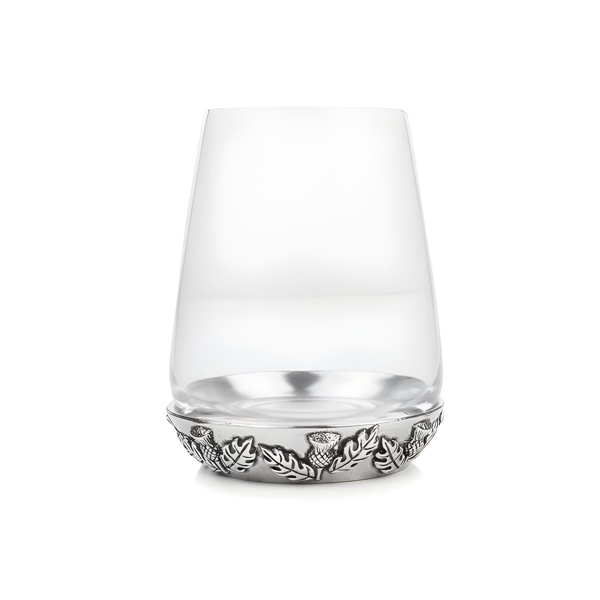 Scottish whisky glass with thistle and leaf design on the base.