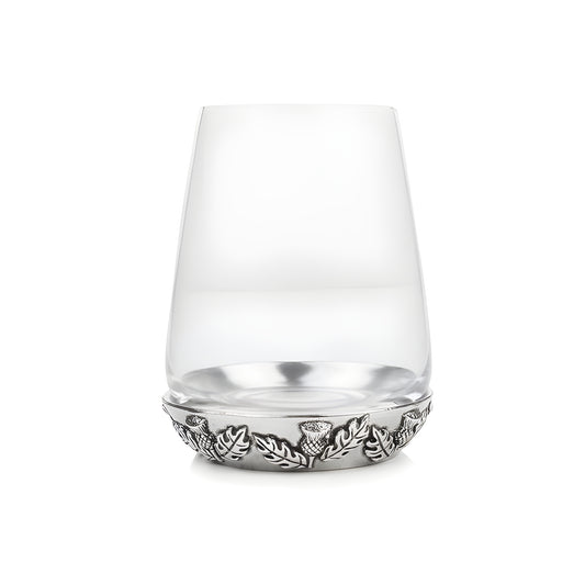 Scottish whisky glass with thistle and leaf design on the base.