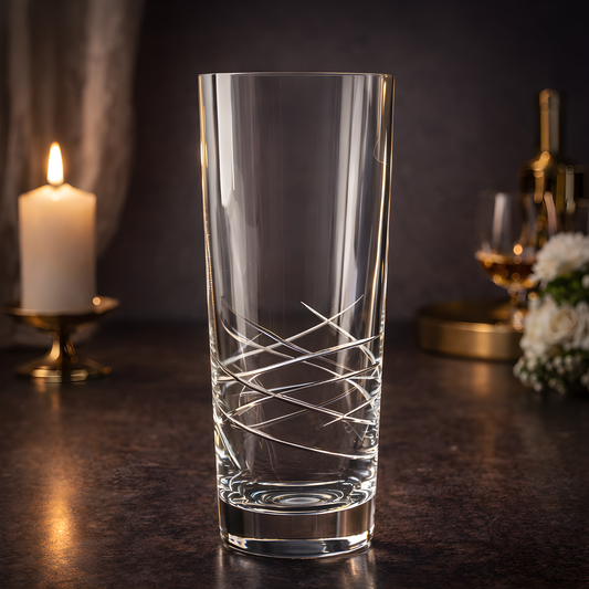 Elegant clear glass conical vase with cut design in candlelit setting.