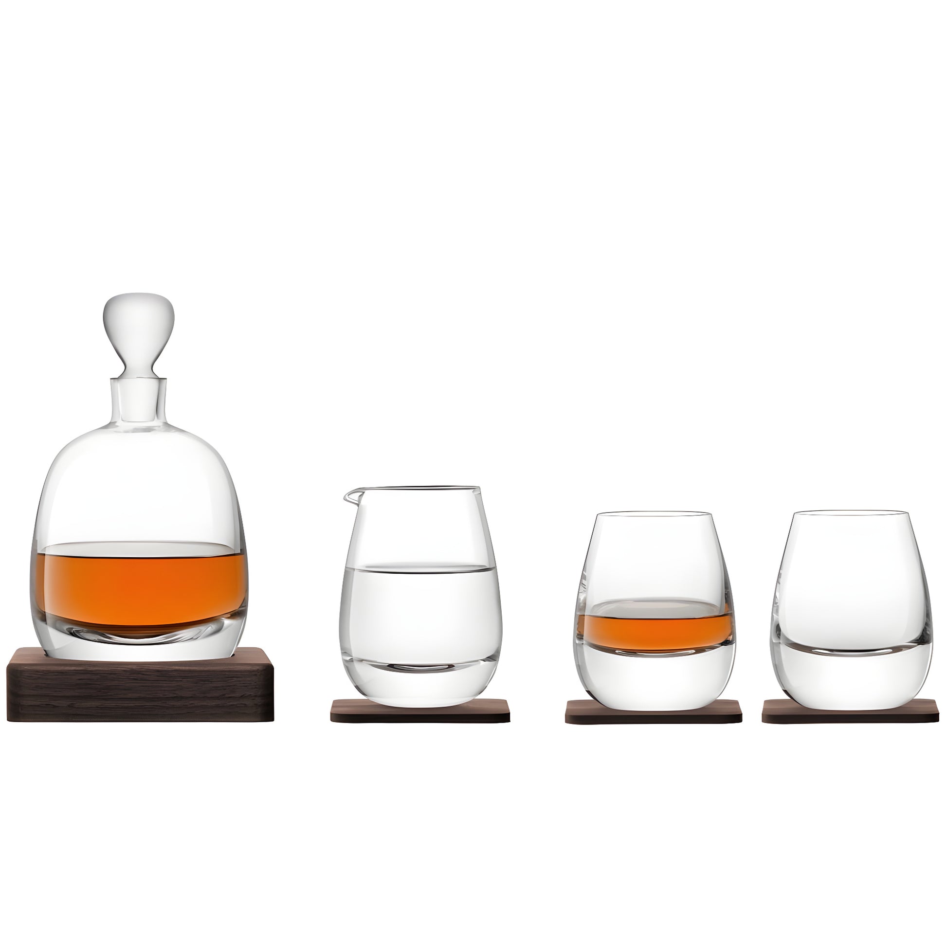Glass decanter and tumblers with whisky on wooden coasters.