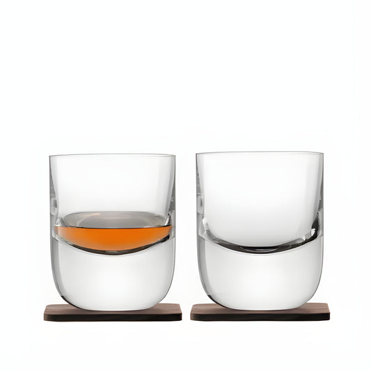 Set of 2 double-wall whisky tumblers with wooden coasters, one filled, one empty.