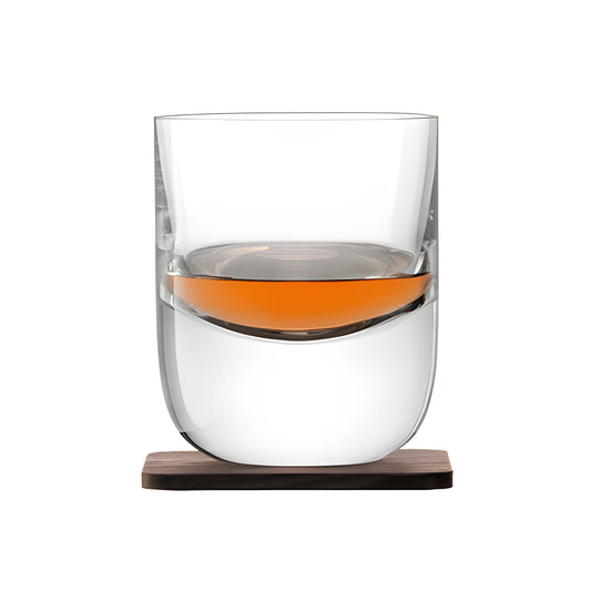 Modern crystal whisky tumbler with wood coaster, partially filled.